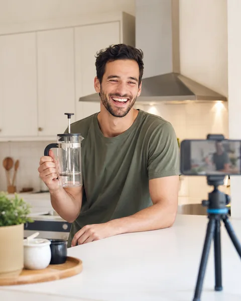 Adult creator recording a second take of a product video on a tripod phone